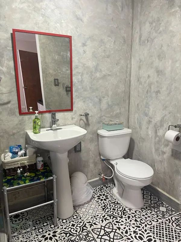 Finished bathroom with a pedestal basin, mixer tap and connected toilet (illustrative image)