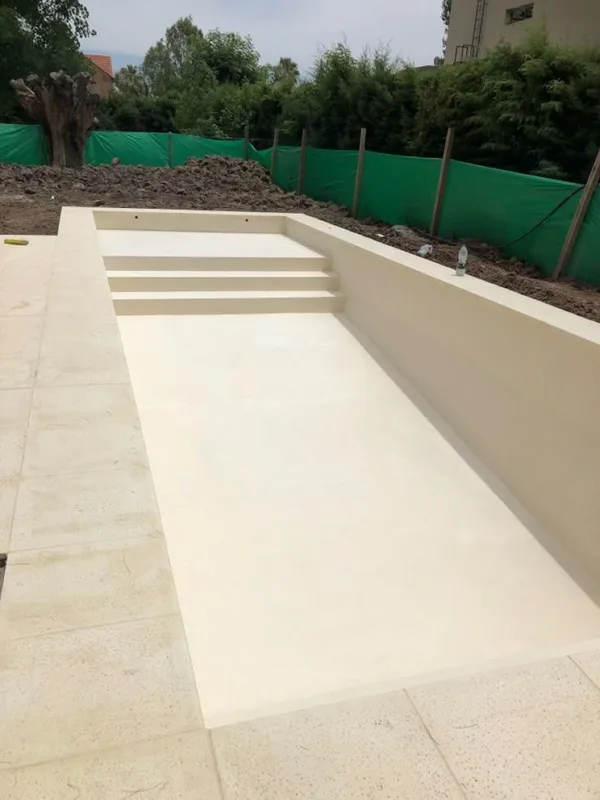 New concrete swimming pool shell with built-in steps before filling (illustrative image)