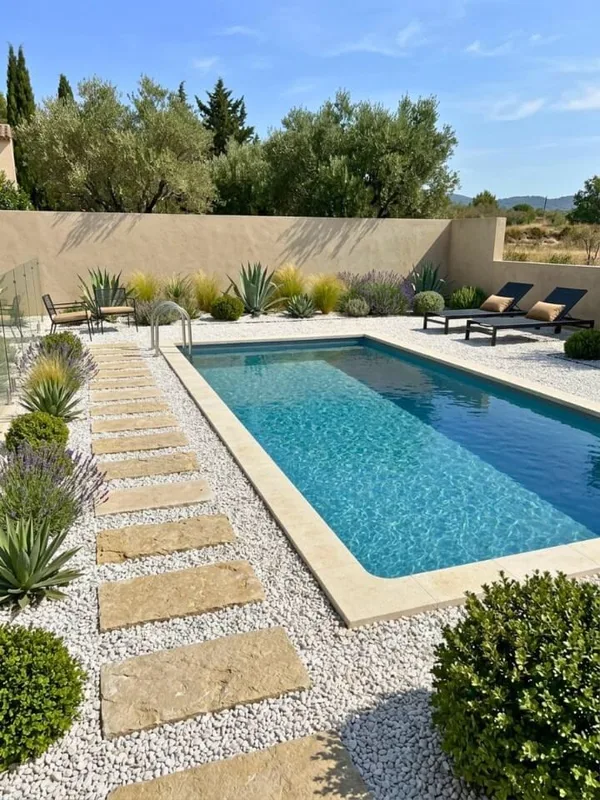Finished rectangular swimming pool with stone coping in a gravel garden (illustrative image)