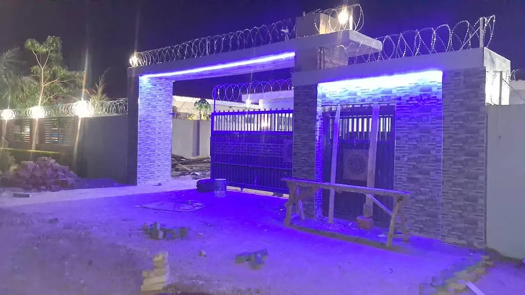 Tiled entrance pillars lit at night with LED strip lighting